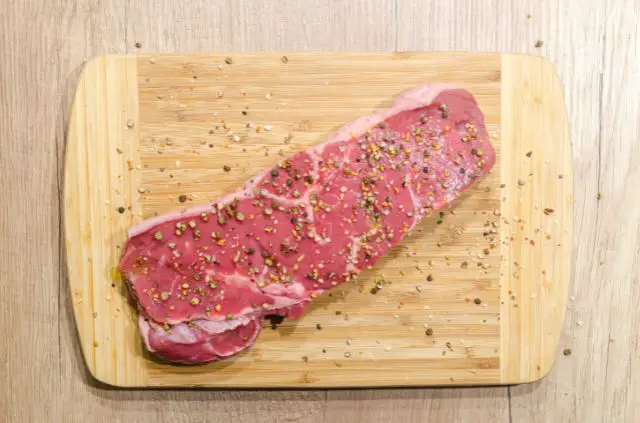raw steak on wood